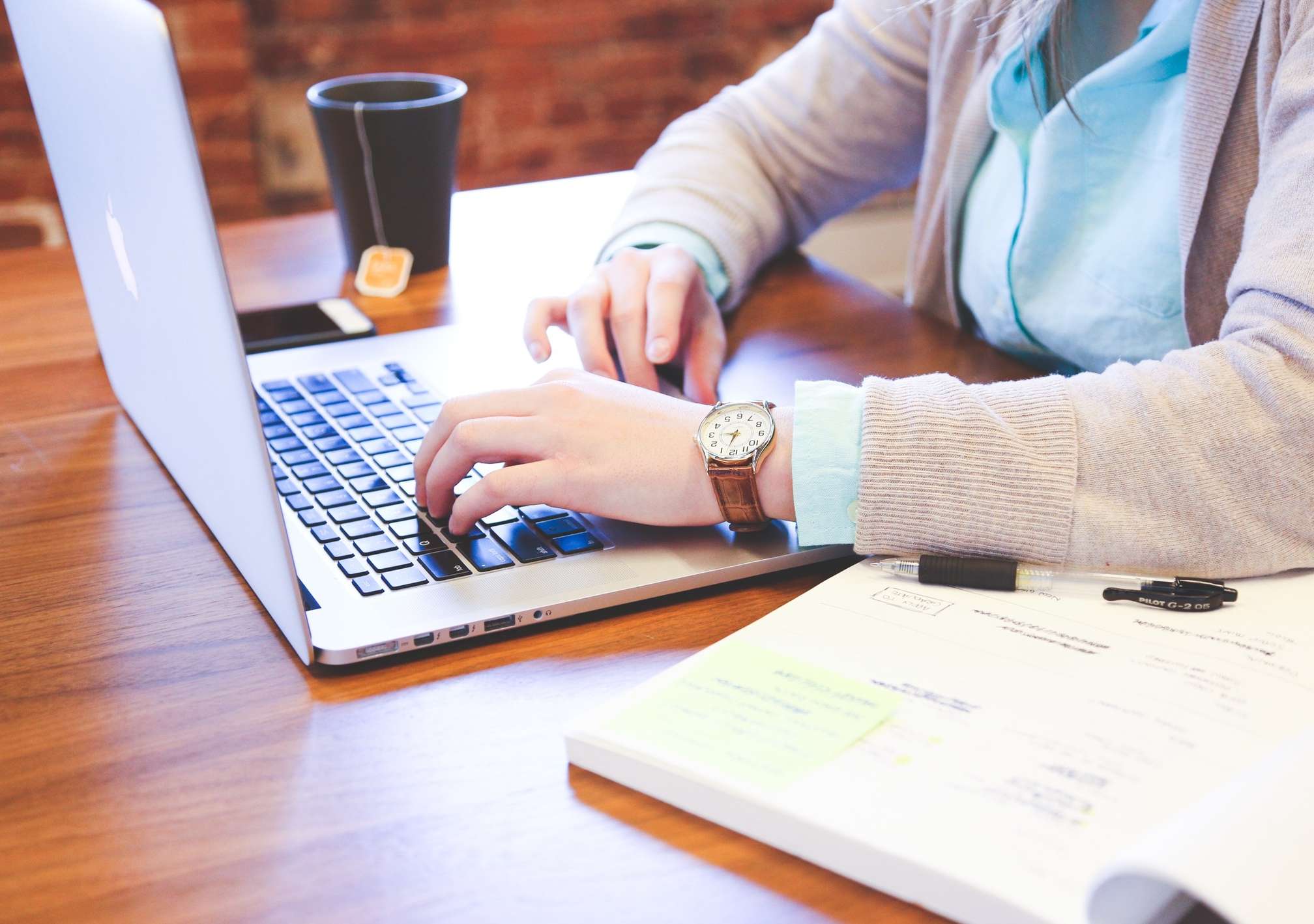 professional entering data on a laptop